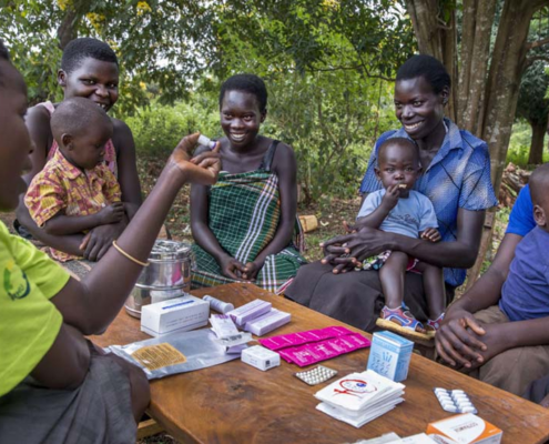 Young mothers getting family planning information from a community health worker in Uganda