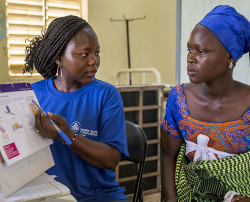 A female health worker provides reproductive health and family planning counseling to a woman