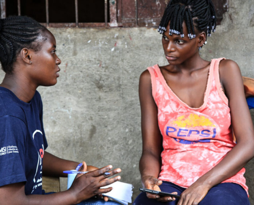 Two seated women in conversation