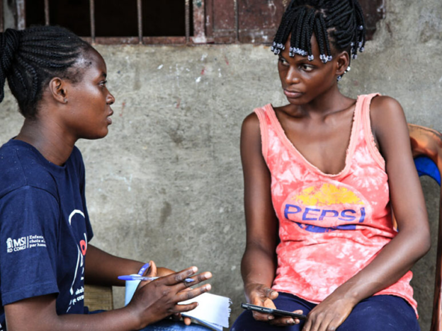 Two seated women in conversation