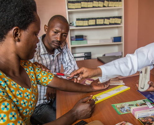 A nurse counsels a couple on family planning in Rwanda