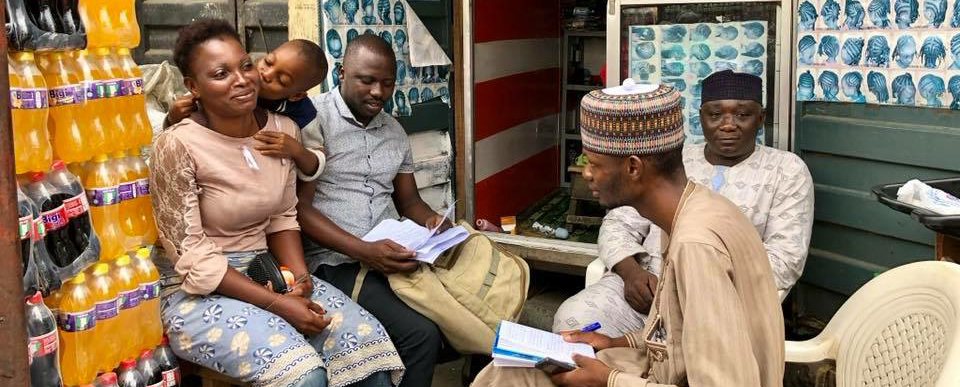 Two men conduct audience analysis in Nigeria