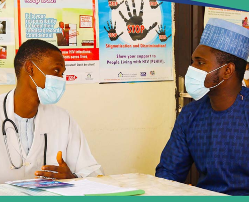 Male healthcare worker counseling male patient in a vaccination clinic