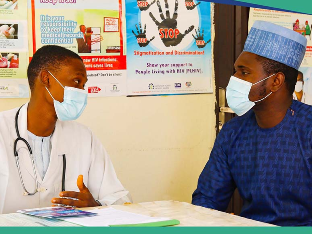 Male healthcare worker counseling male patient in a vaccination clinic